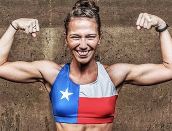 Photo of Cristin Curl in a red, white, and blue sports bra, flexing