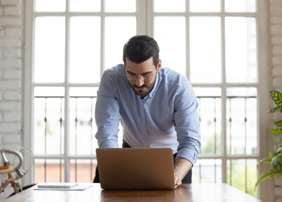 male business owner checking tax refund on computer